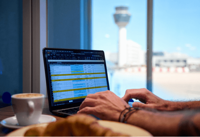 Person using a laptop at the business lounge of Athens International Airport